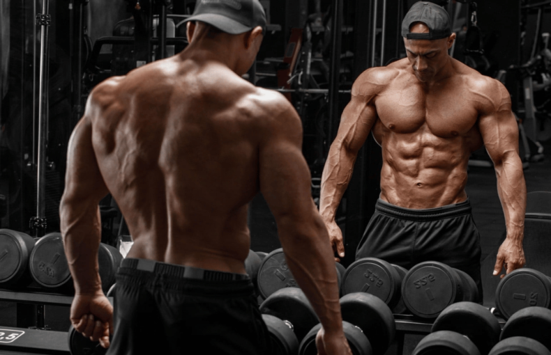 Physique athlete analyzing performance recovery and sustainable training progression